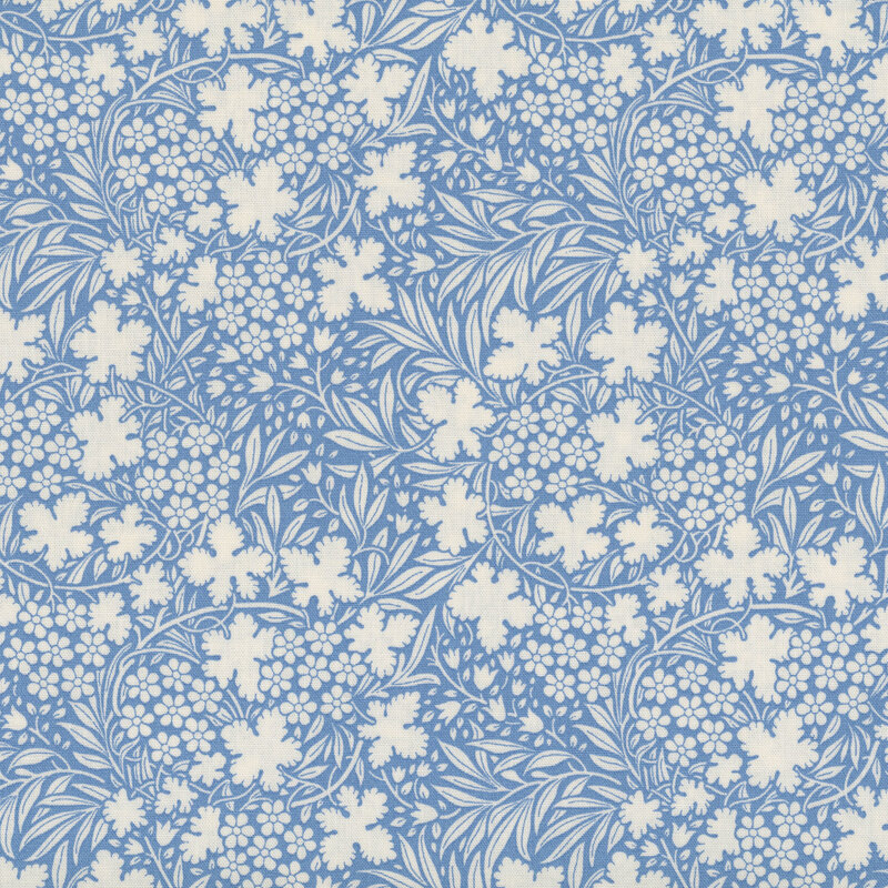 Blue fabric with a dense pattern of white florals and leaves for a cohesive design.