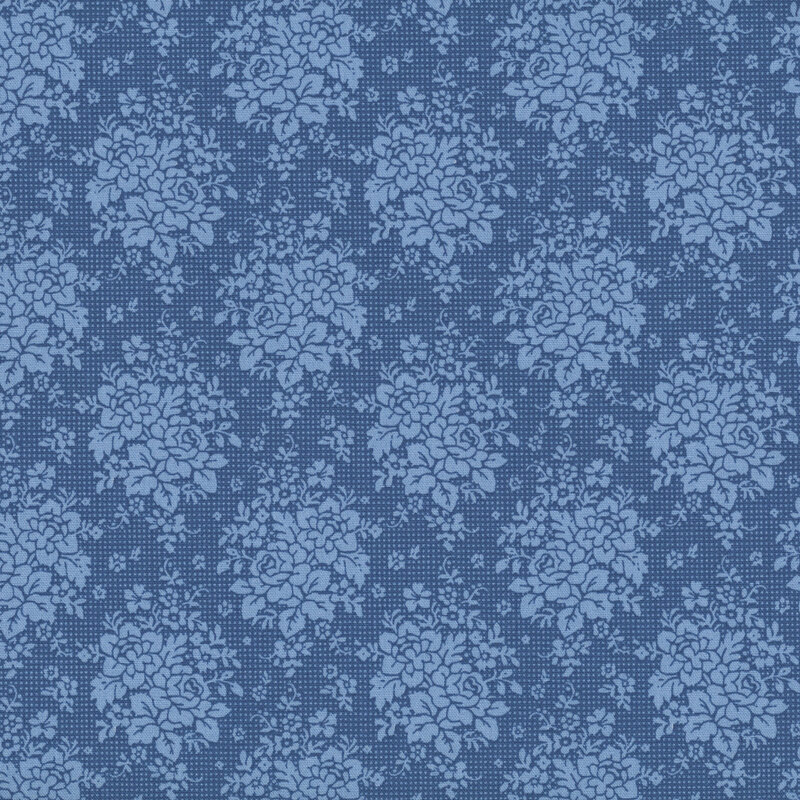 Blue fabric with an ornamental pattern of floral clusters and leaves, creating a refined and decorative design.