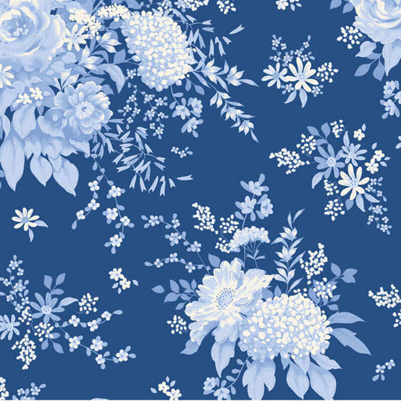 Blue fabric with a toile-inspired design of large floral clusters and leaves for a classic, elegant look.