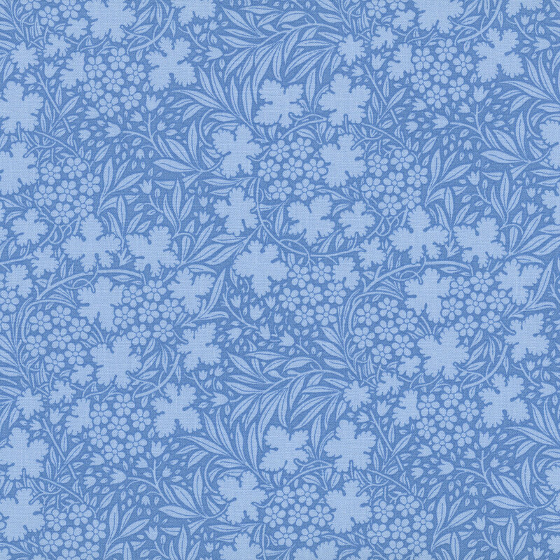 Blue fabric with a dense pattern of tonal florals and leaves for a cohesive design.