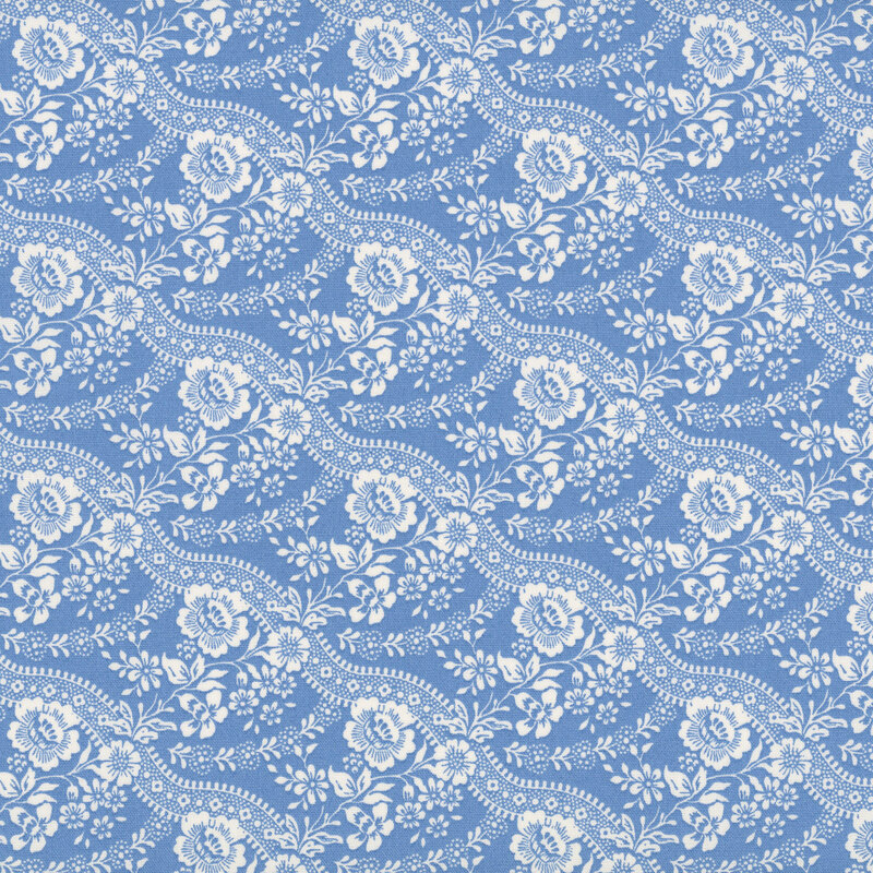 Blue fabric with stripes of stylized flowers paired with wavy lines for a graceful, flowing design.