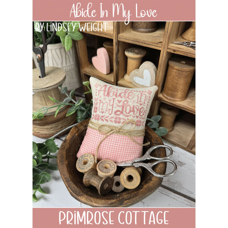 The front of the Abide In My Love cross stitch pattern by Primrose Cottage Stitches showing the finished project.