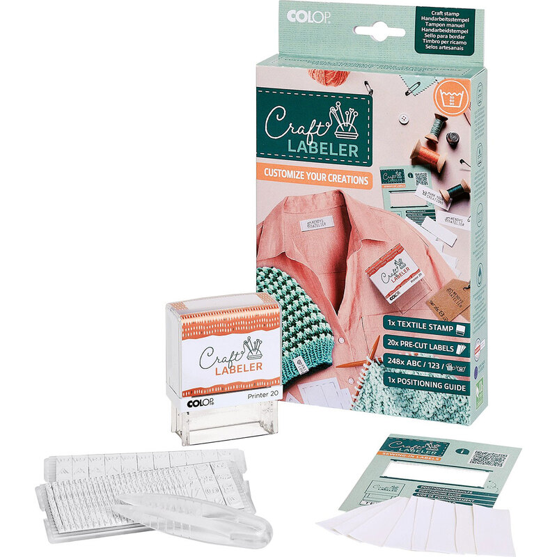Craft label maker kit with textile stamp, pre-cut labels, positioning guide, and clear stamp holder.
