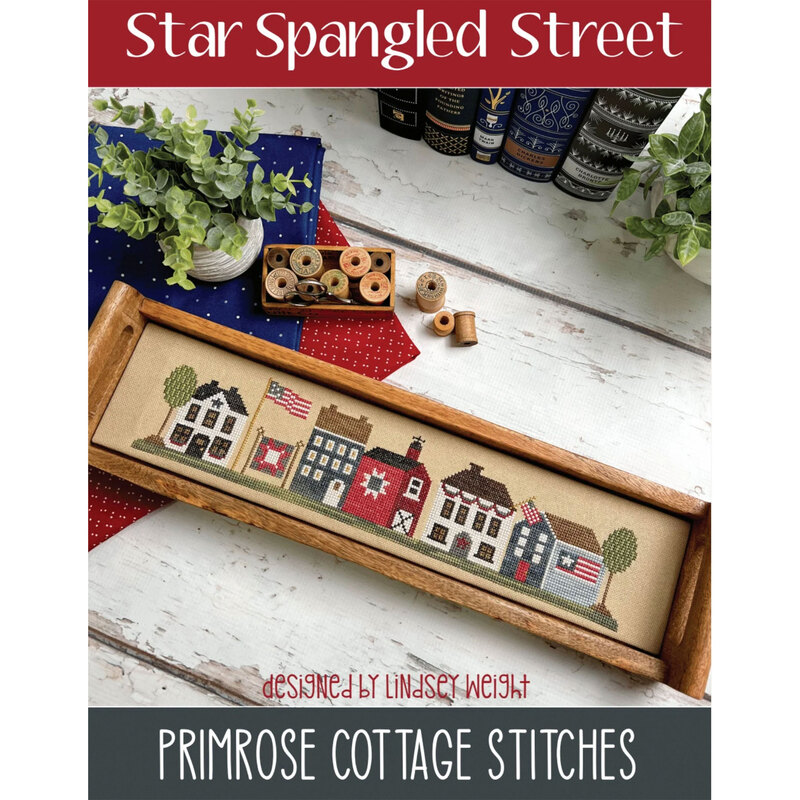 The front of the Star Spangled Street cross stitch pattern by Primrose Cottage Stitches showing the finished project.