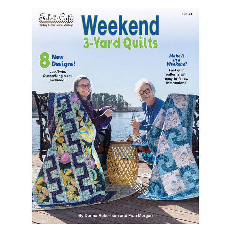 The front cover of the Weekend 3-Yard Quilts pattern book, featuring the two designers sitting dockside and staged with quilts. 