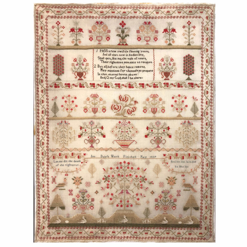 A close up shot of the completed cross stitch, isolated on a white background. 