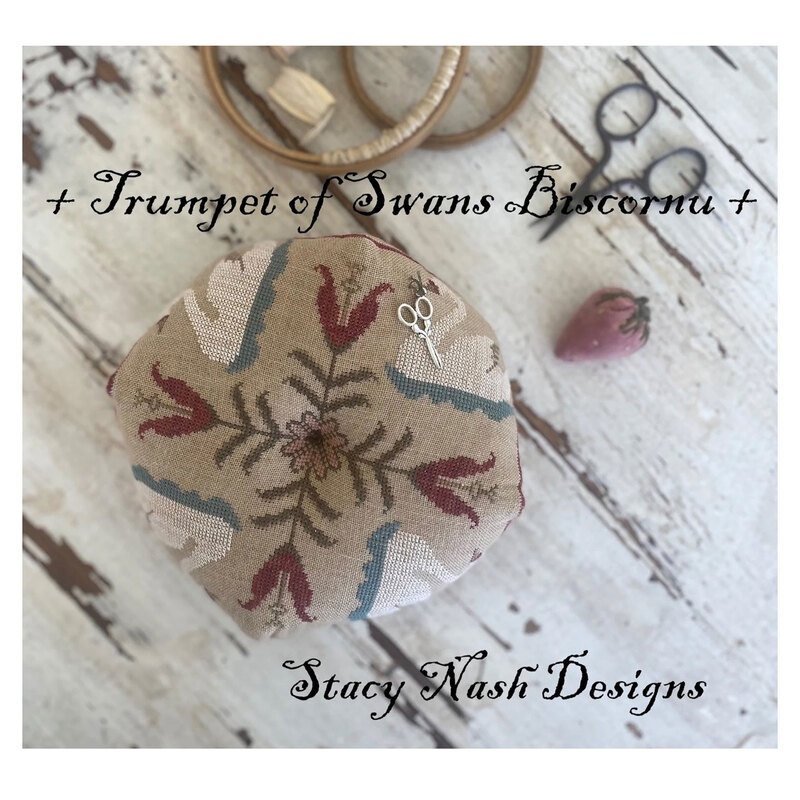 Front image of the Trumpet of Swans Biscornu pattern featuring the completed project.