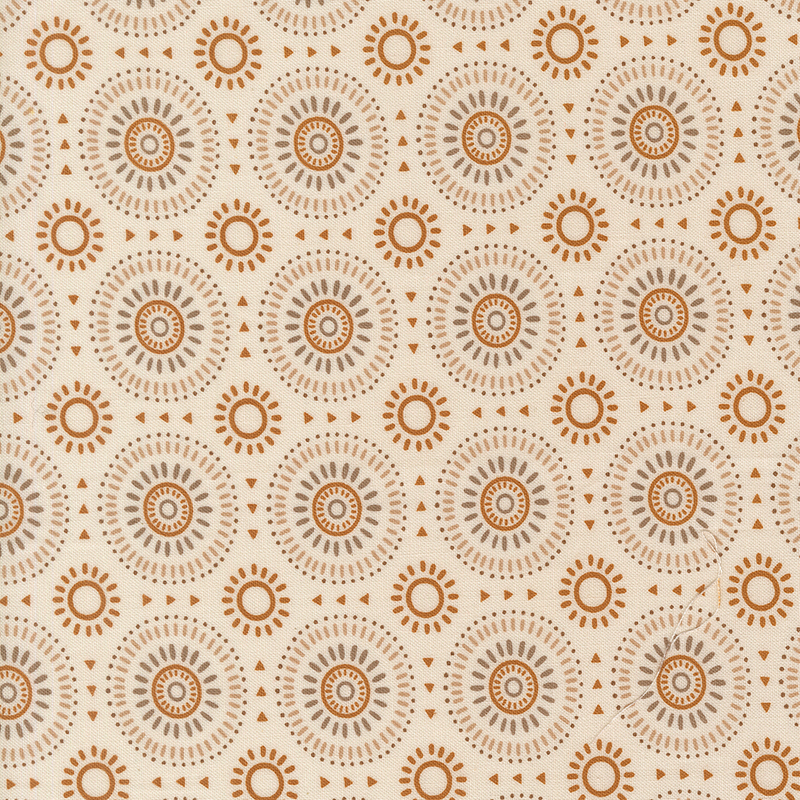 Light beige fabric featuring a geometric sunburst pattern in hues of gold, tan, and taupe. 