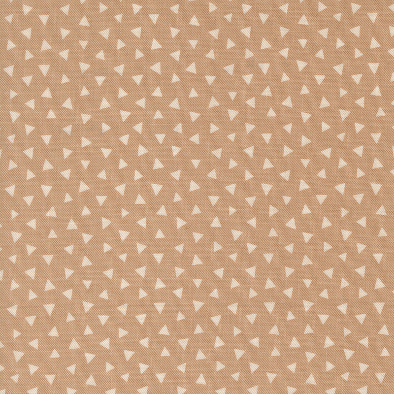 Light tan fabric featuring a tossed pattern of tonal triangles.