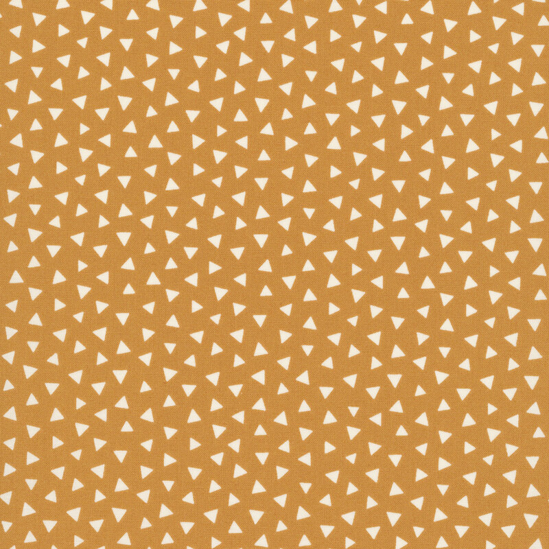 Warm caramel fabric featuring a tossed pattern of light beige triangles.