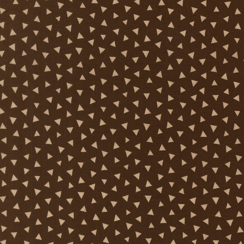 Light tan fabric featuring a tossed pattern of tonal triangles.