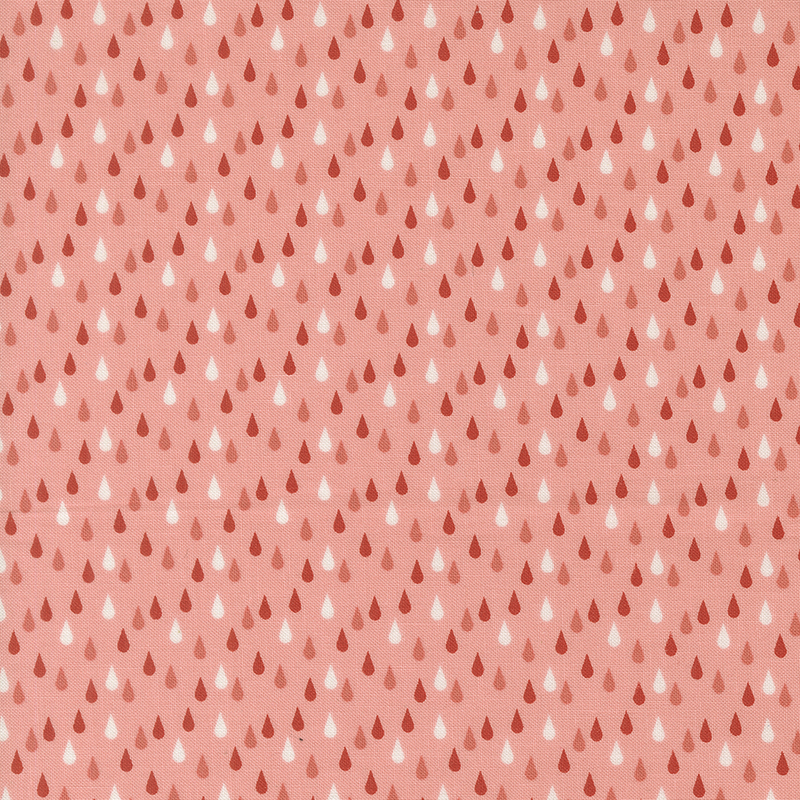 This salmon pink fabric features red, pink and white rain drops. 