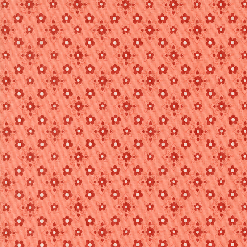Salmon orange fabric featuring a repeating pattern of small red florals with stylized floral medallions in hues of red, peach, and white.