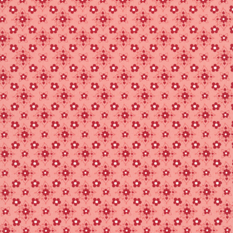 Salmon orange fabric featuring a repeating pattern of small red florals with stylized floral medallions in hues of red, peach, and white.