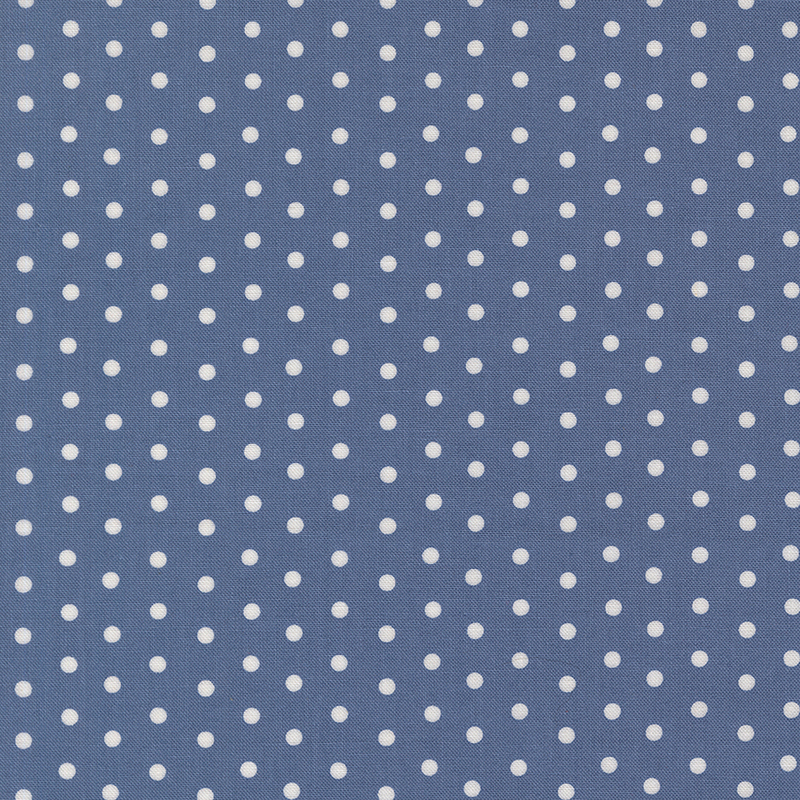 Denim blue fabric with a white polka dot pattern.