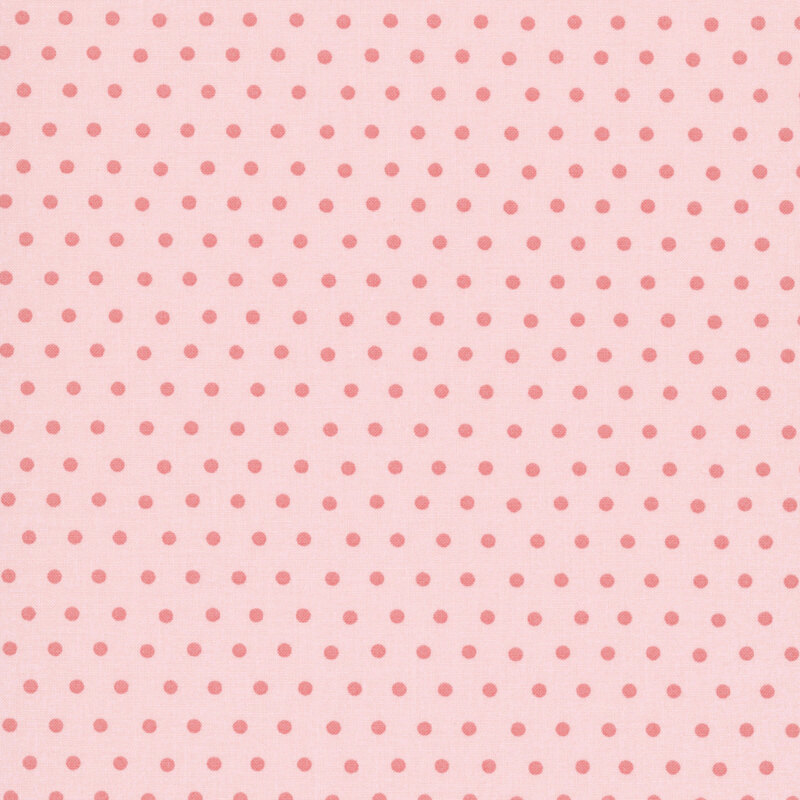 Peach fabric with a coral polka dot pattern.
