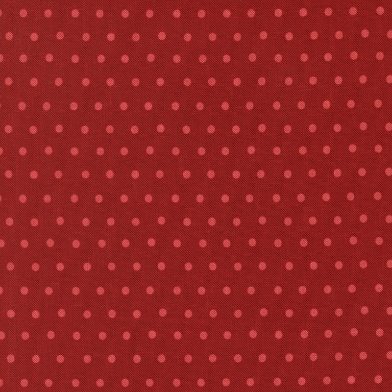 Dark red fabric with a watermelon red polka dot pattern.