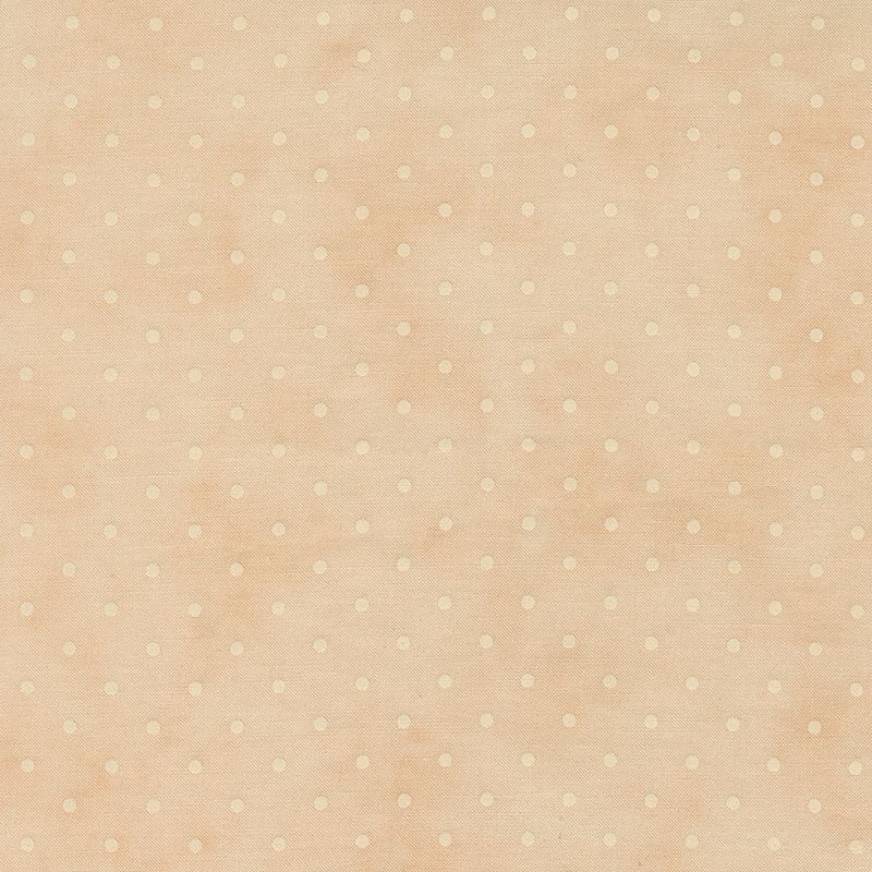 Tonal polka dot print on a mottled light peach background.