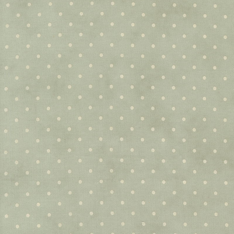 Tonal polka dot print on a mottled dusty blue green background.