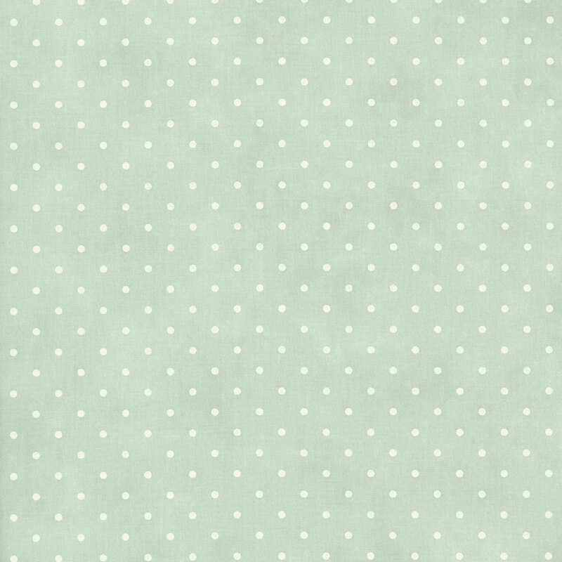 polka dot print on a mottled dusty blue green background.