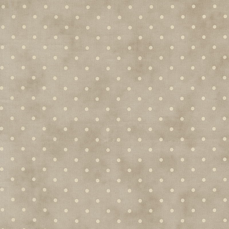 Tonal polka dot print on a mottled light taupe background.