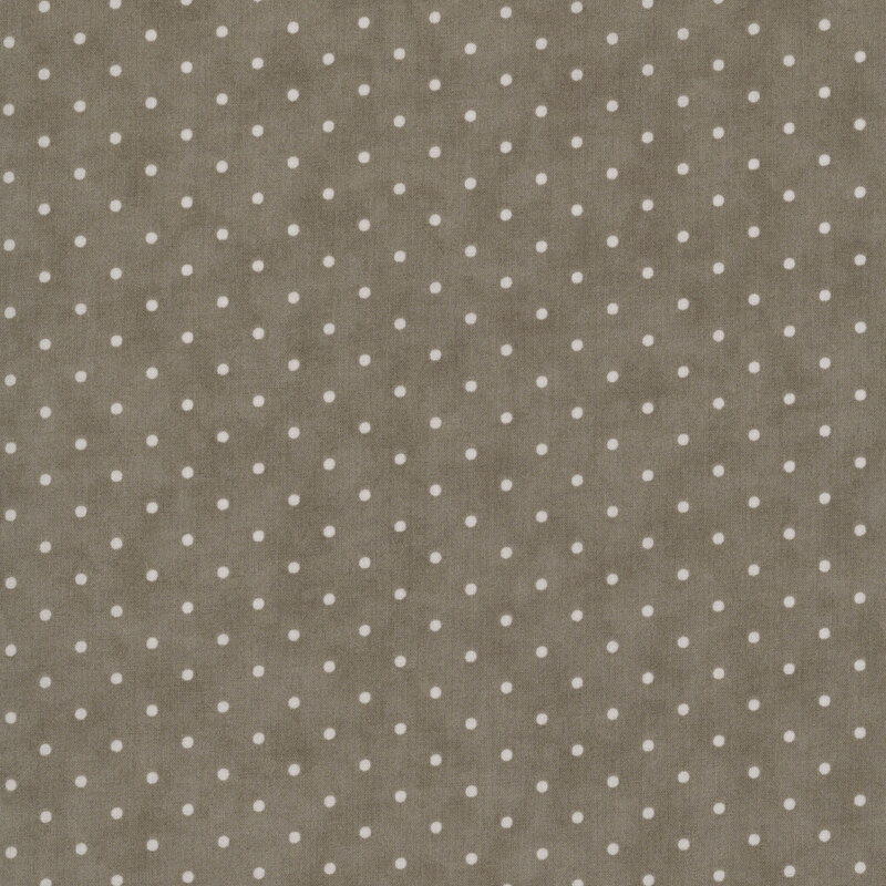 Tonal polka dot print on a mottled dark taupe background.