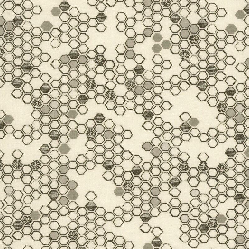 This cream fabric features a hand drawn design of black and grey hexagons. 