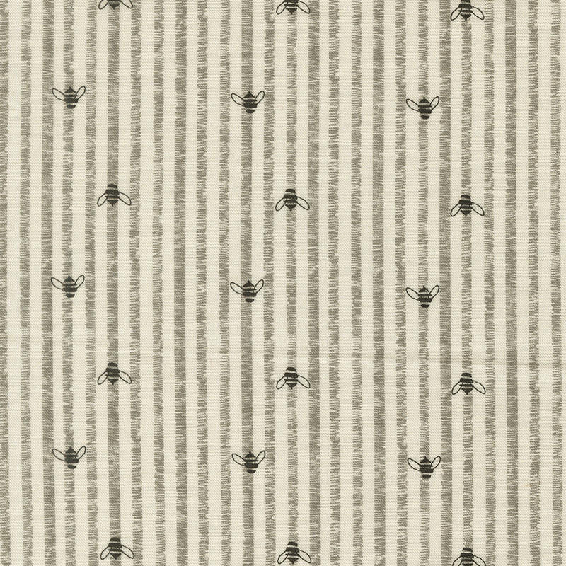 This cream fabric features rustic grey stripes accented with charming hand drawn bees.