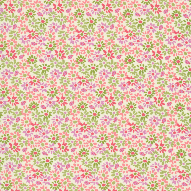 This cream fabric features densely packed flowers and ladybugs in shades of pink, coral, and mauve for a lush and vibrant floral design.