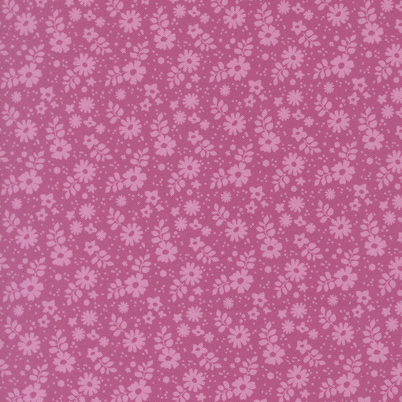This tonal magenta fabric features tossed florals.