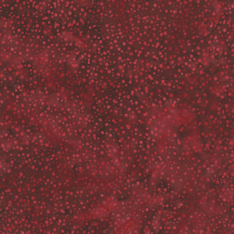 red fabric with a pattern of tonal dots on a mottled background.