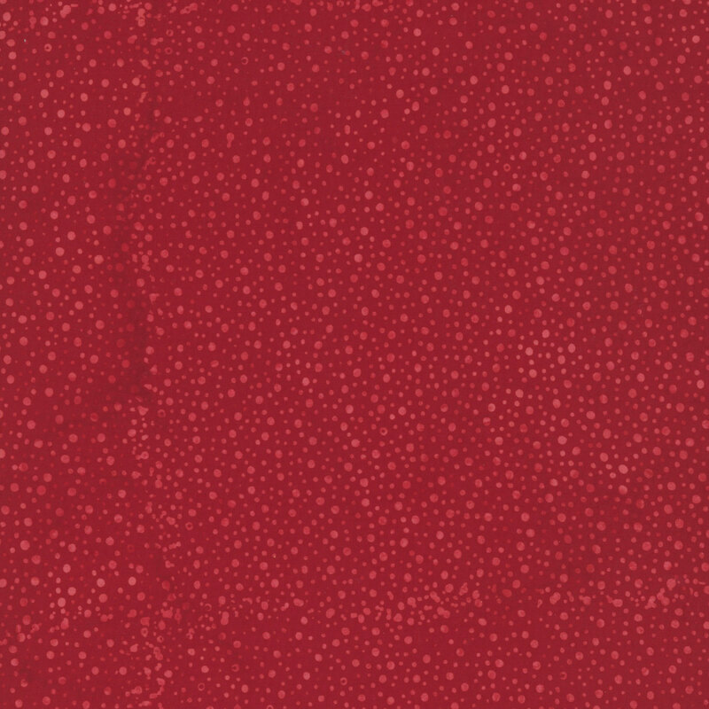 red fabric with a pattern of tonal dots on a mottled background.