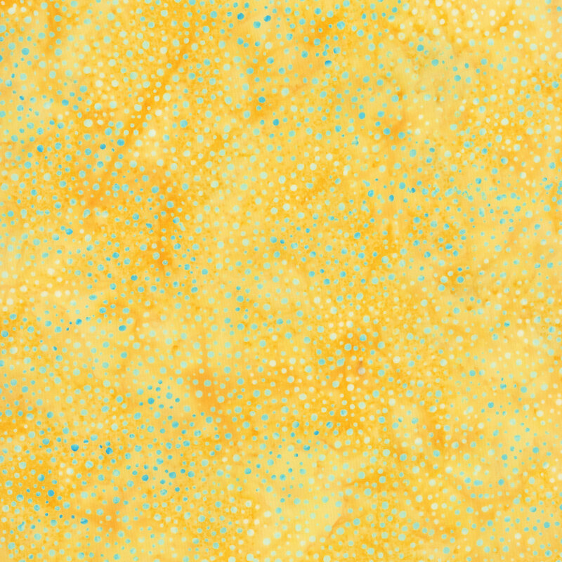 yellow fabric with a pattern of aqua dots on a mottled background.