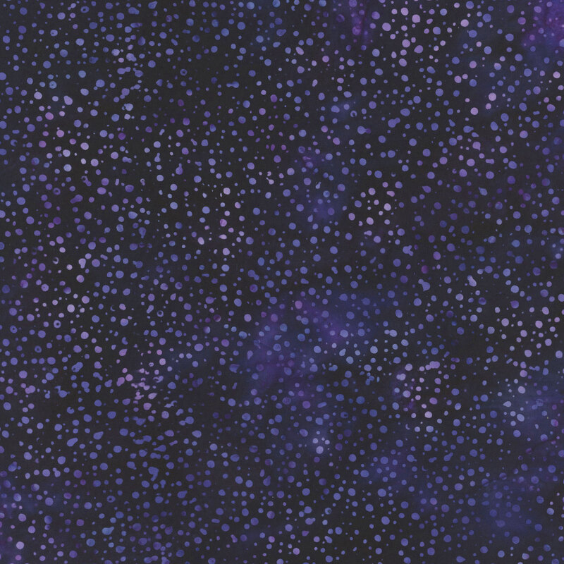 purple fabric with a pattern of dots on a mottled background.