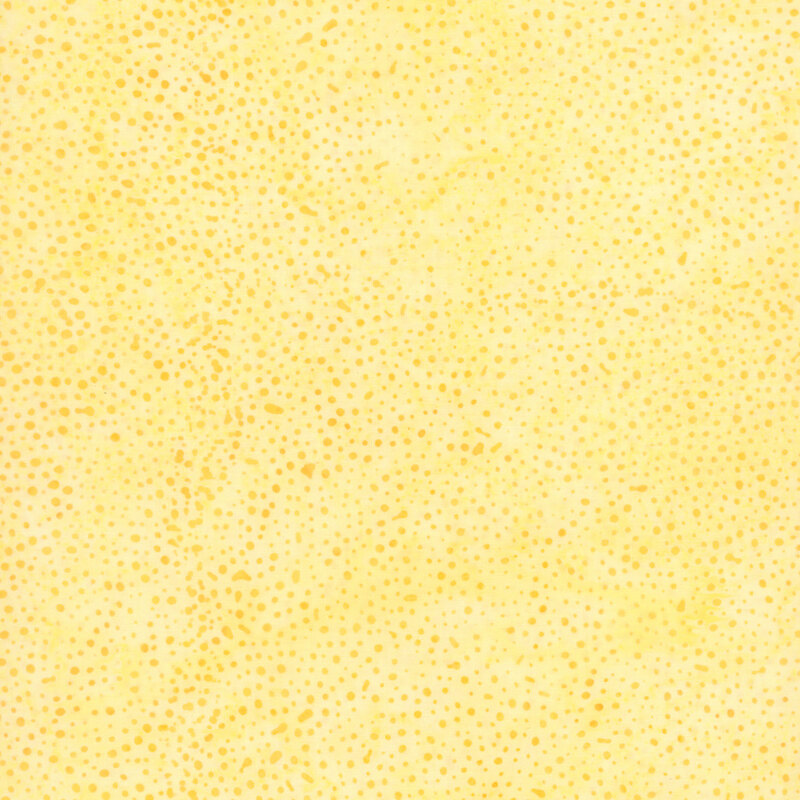 bright yellow fabric with a pattern of yellow and orange dots on a mottled background.