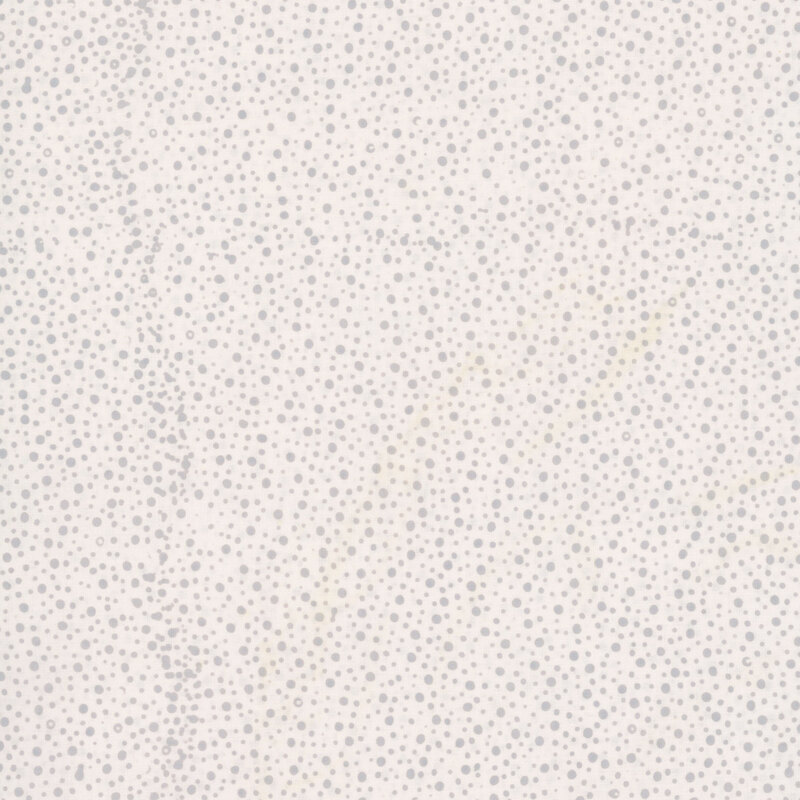 white fabric with a pattern of gray dots on a mottled background.