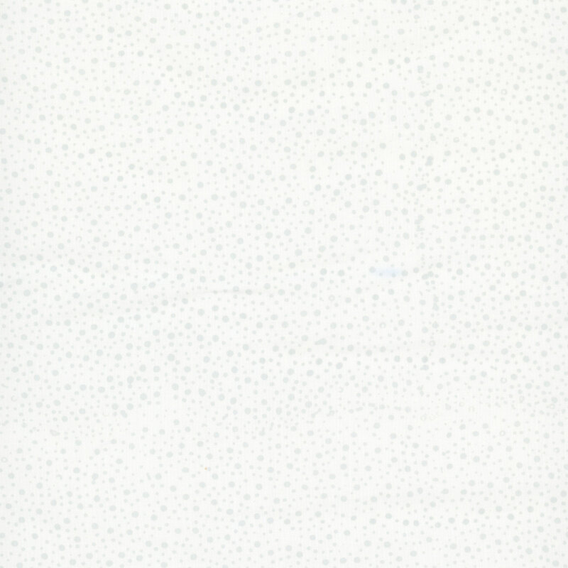 white fabric with a pattern of tonal dots on a mottled background.