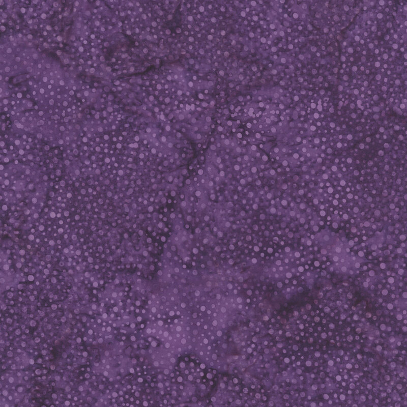 purple fabric with a pattern of tonal dots on a mottled background.