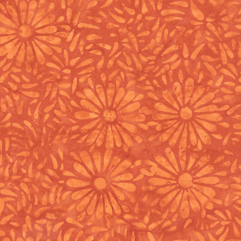 Rich orange batik featuring a repeating daisy petal motif.