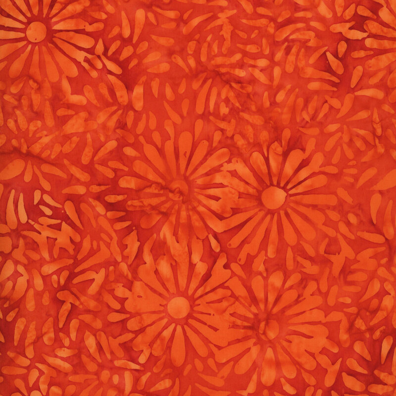 Rich orange batik featuring a repeating daisy petal motif.