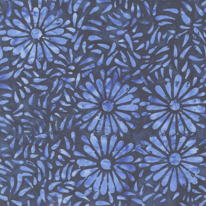 Dark blue batik featuring a repeating vibrant iris daisy petal motif.