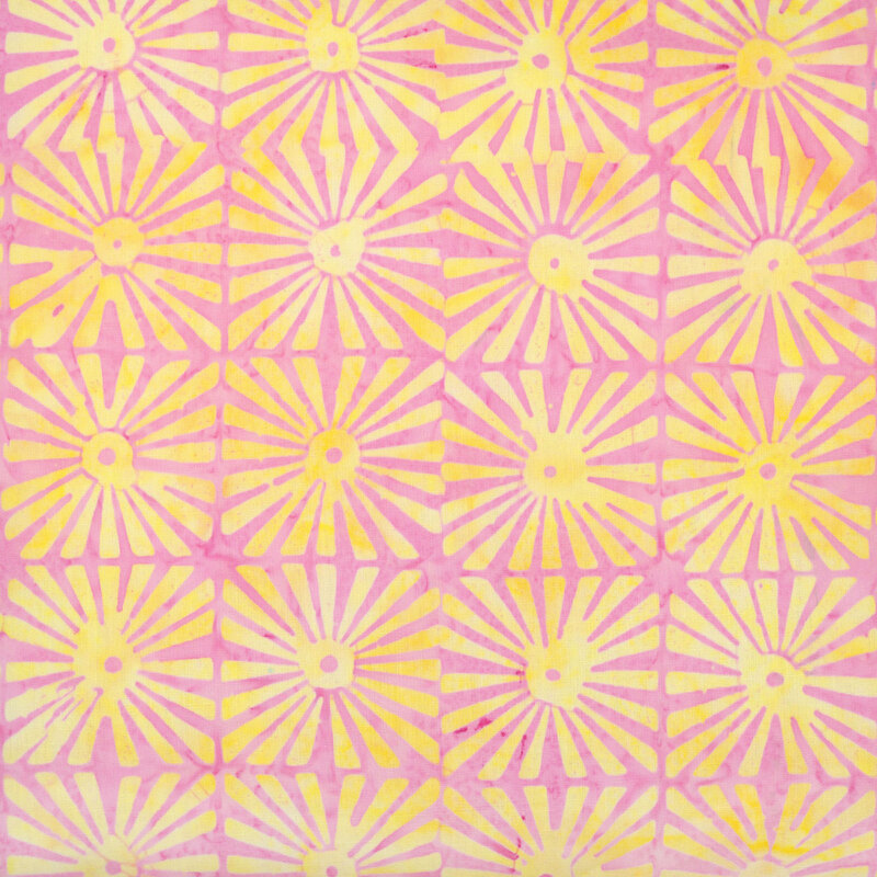 Faded bubblegum pink batik fabric featuring grids of yellow sunburst motifs.