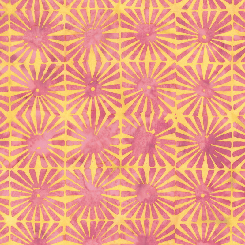 mottled yellow batik fabric featuring grids of passion pink sunburst motifs.