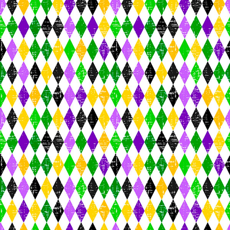 A white fabric with green, yellow, black, and purple harlequin diamonds. 