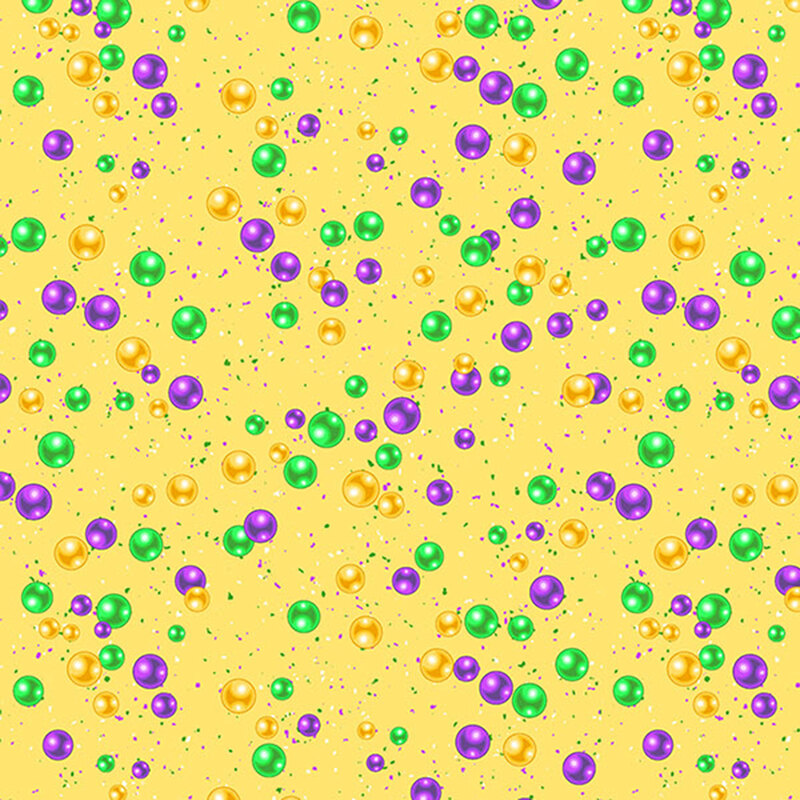 This butter yellow fabric features confetti and mardi gras beads. 