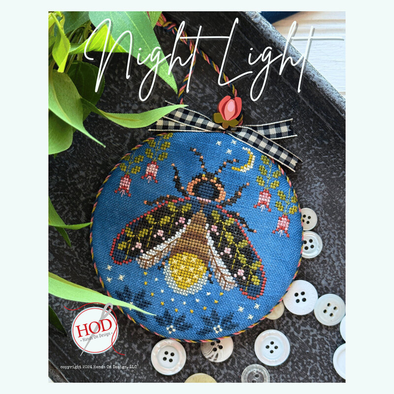 Front image of the Night Light Pattern featuring a lightning bug, florals, and a crescent moon on a blue background.