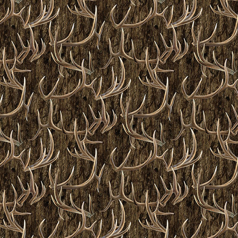 Woodgrain fabric layered with scattered antlers.