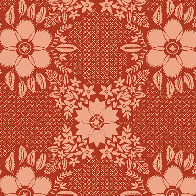 Rusty orange fabric with coral orange embroidered crosses between blooming florals and leaves.
