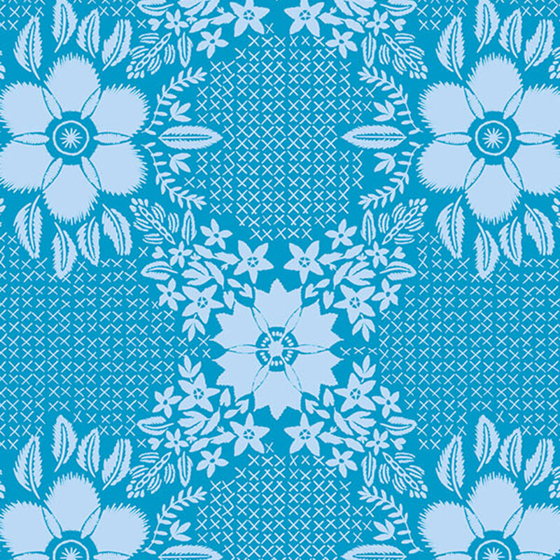 Cornflower blue fabric with pastel blue embroidered crosses between blooming florals and leaves.