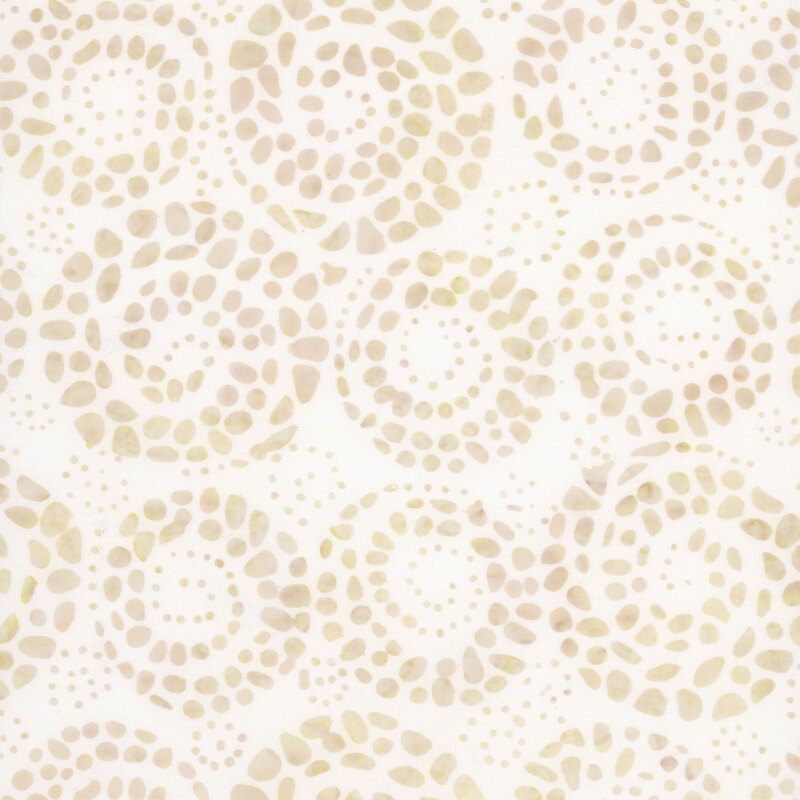 White batik fabric with a pattern of cream dots formed by smaller dots and spots.